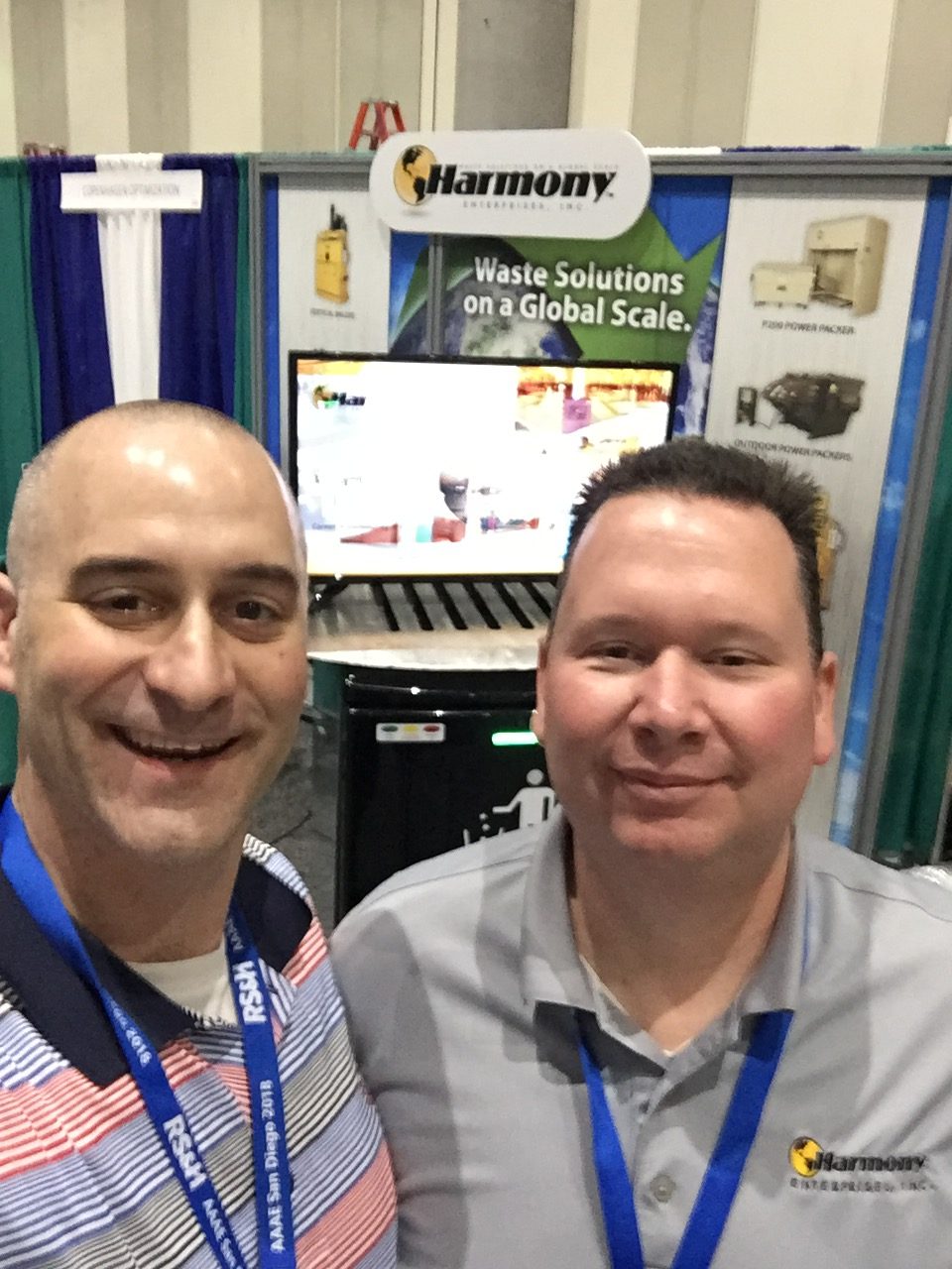 Lane Powell and Nick Roberts set up their booth with solutions for airport waste at the AAAE show