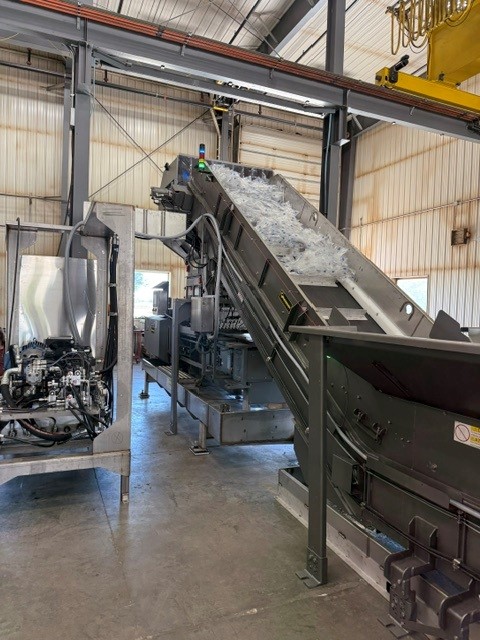 custom conveyor moves the IV bags up to the machine for recycling